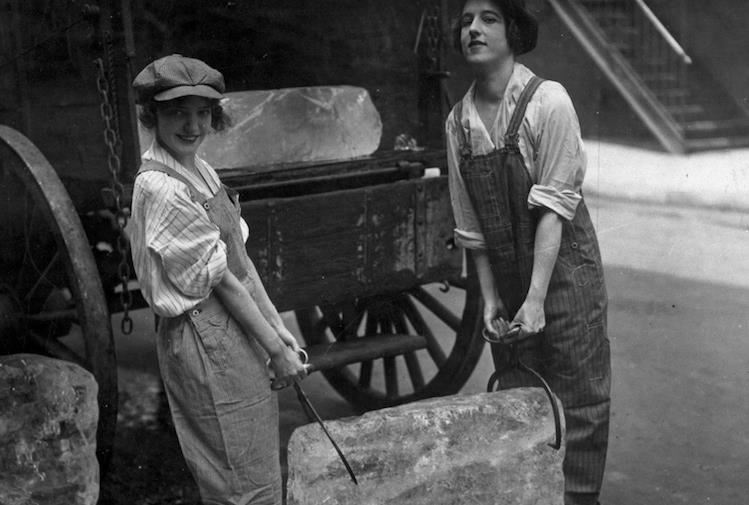 Historical photo of two young women carrying ice