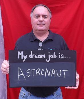 Man holding sign that says My Dream Job is Astronaut