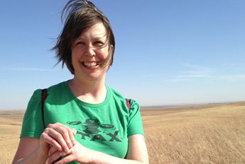 woman standing in tall grass prairie
