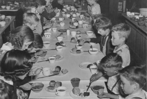 Children eat school lunch in Gardner, Kansas. Black and white.