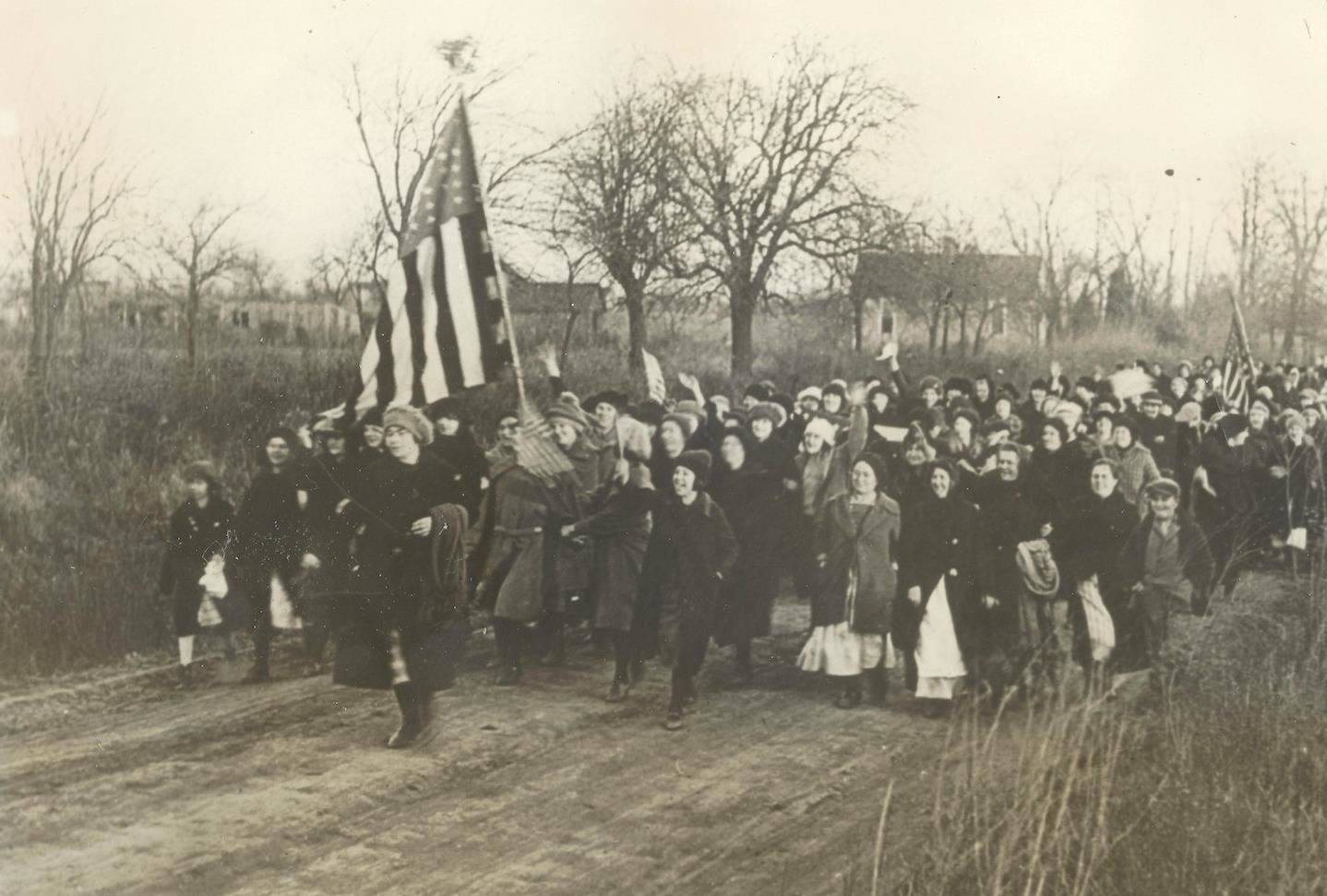 group of women marching holding American flag