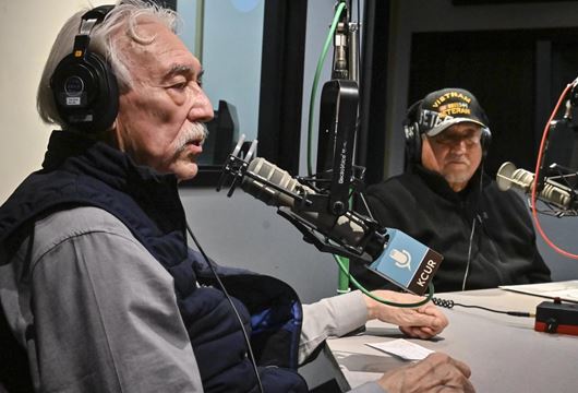 Two men being interviewed a radio station