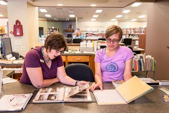 Library employees working on photo preservation project. 