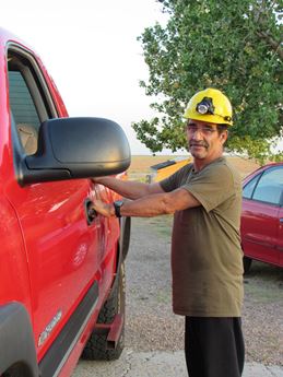 Man in hard hat by truck