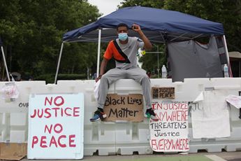 man sitting on a barricade