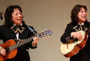 two women playing mariachi music