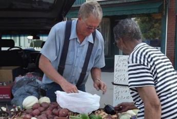 people shopping a farmers market