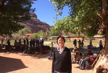 A woman stands in front of the Supai Village at the bottom of the Grand Canyon