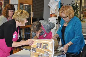 Women looking at scrapbook