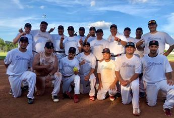 A softball team poses together.