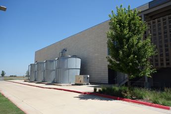Rainwater retention tanks stand on the side of Kiowa County High School in Greensburg, Kansas. 