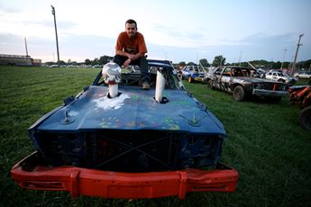 man sitting on car