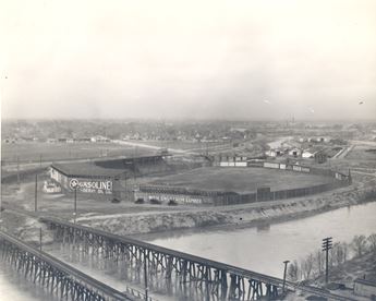 Black and white photo of a baseball stadium positioned by the Arkansas River