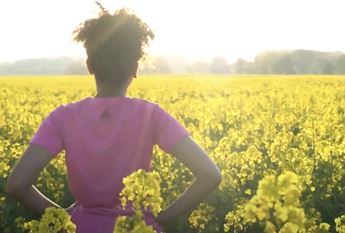 girl looking at field of flowers