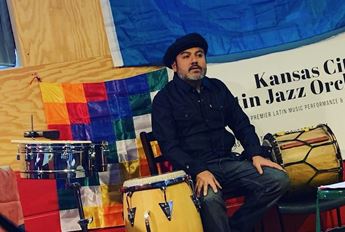man sitting by drum kit
