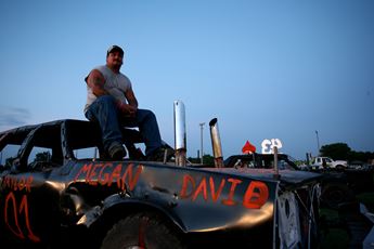 man sitting on car