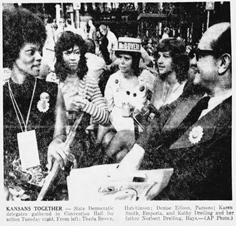 Newspaper photo of women and man at a campaign rally