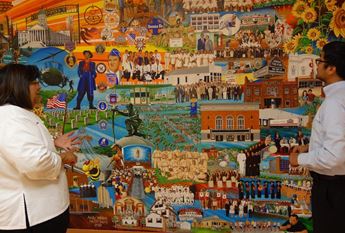 woman and man looking at mural