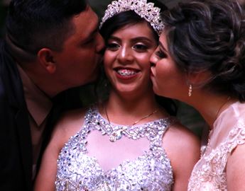 Parents kissing daughter on the cheek