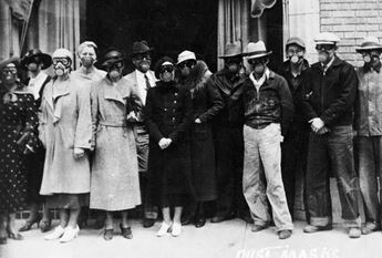 men and women in gas masks during dust storm