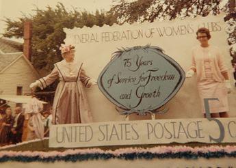 Two women standing on a parade float