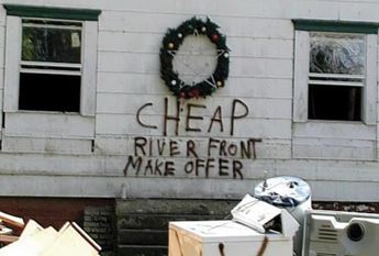 One home owner spray-painted "Cheapr River Front Make Offer" on their flooded home in Fredonia in 2007.