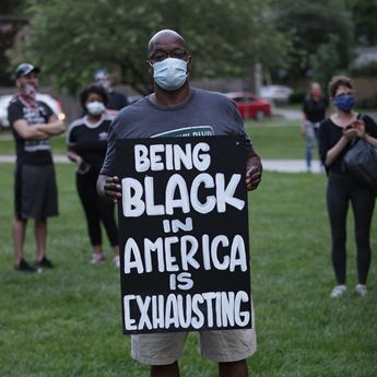 man holding protest sign