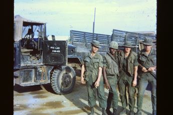 US soldiers in front of a supply convoy in Vietnam