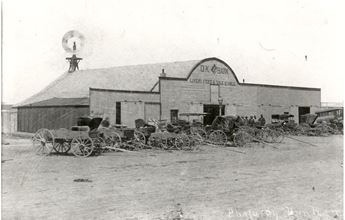 Barn with carriages in front in Colby, Kansas. Black and white.