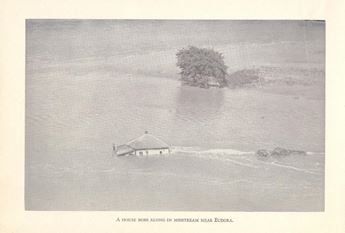 A house floats along in the 1951 flood near Eudora.