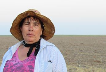 Woman in hat with Kansas landscape in background