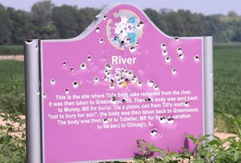 sign with bullet holes in it