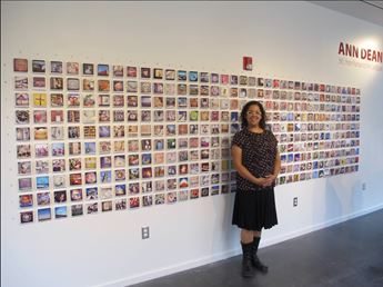 woman in front of photo exhibit