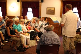 Reader reading at Shared Stories event in Lawrence