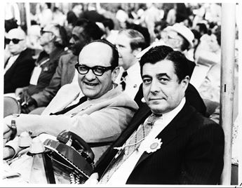 Two men sitting in audience
