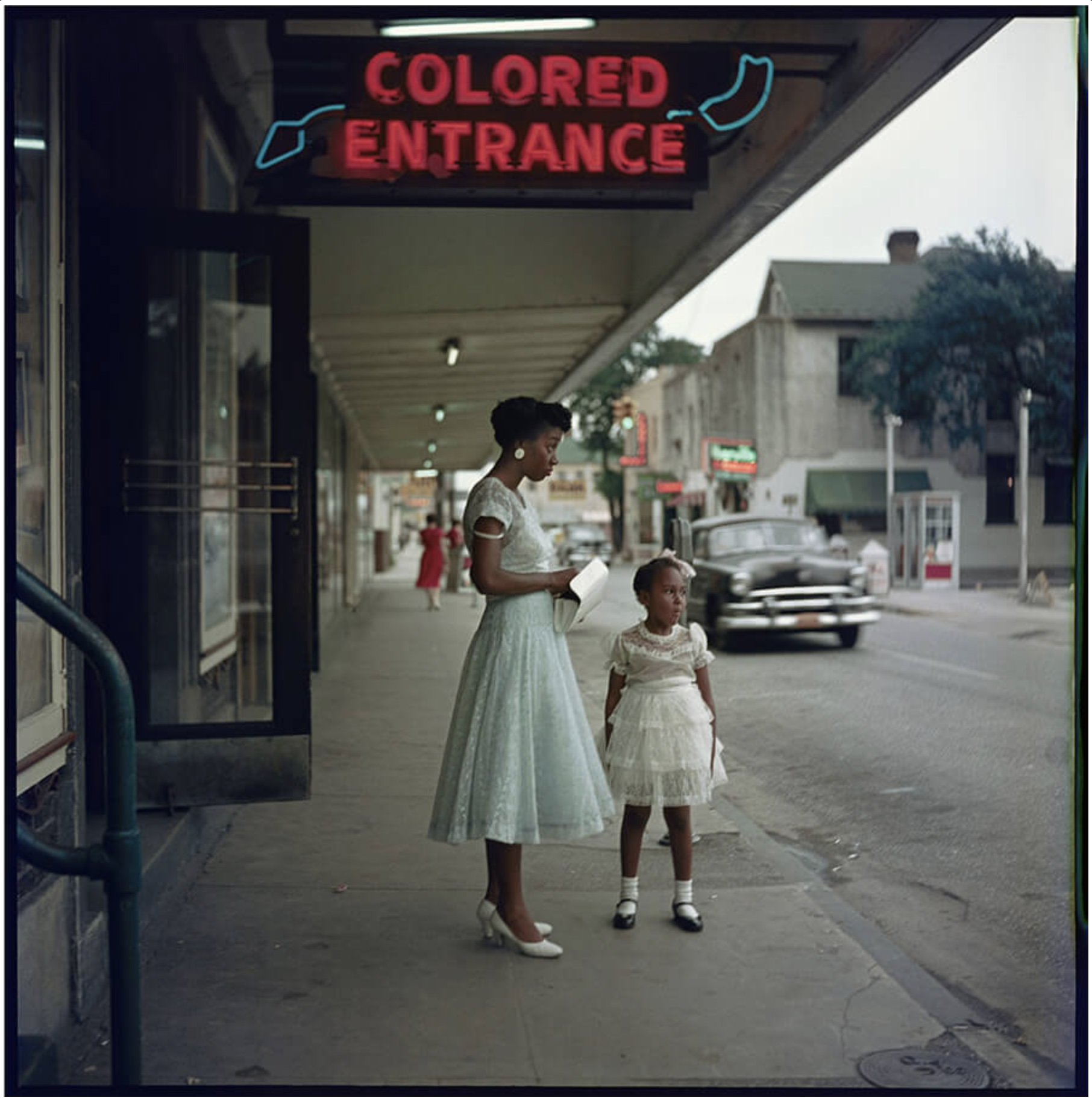 women and girl outside segregated entrance of a department store