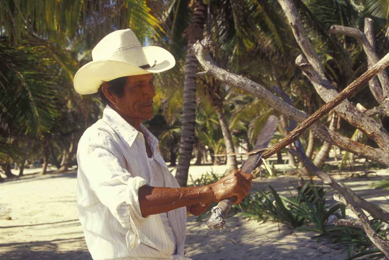 man carving a stick