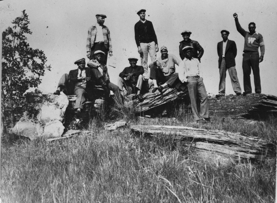 men sitting outside in 1920s