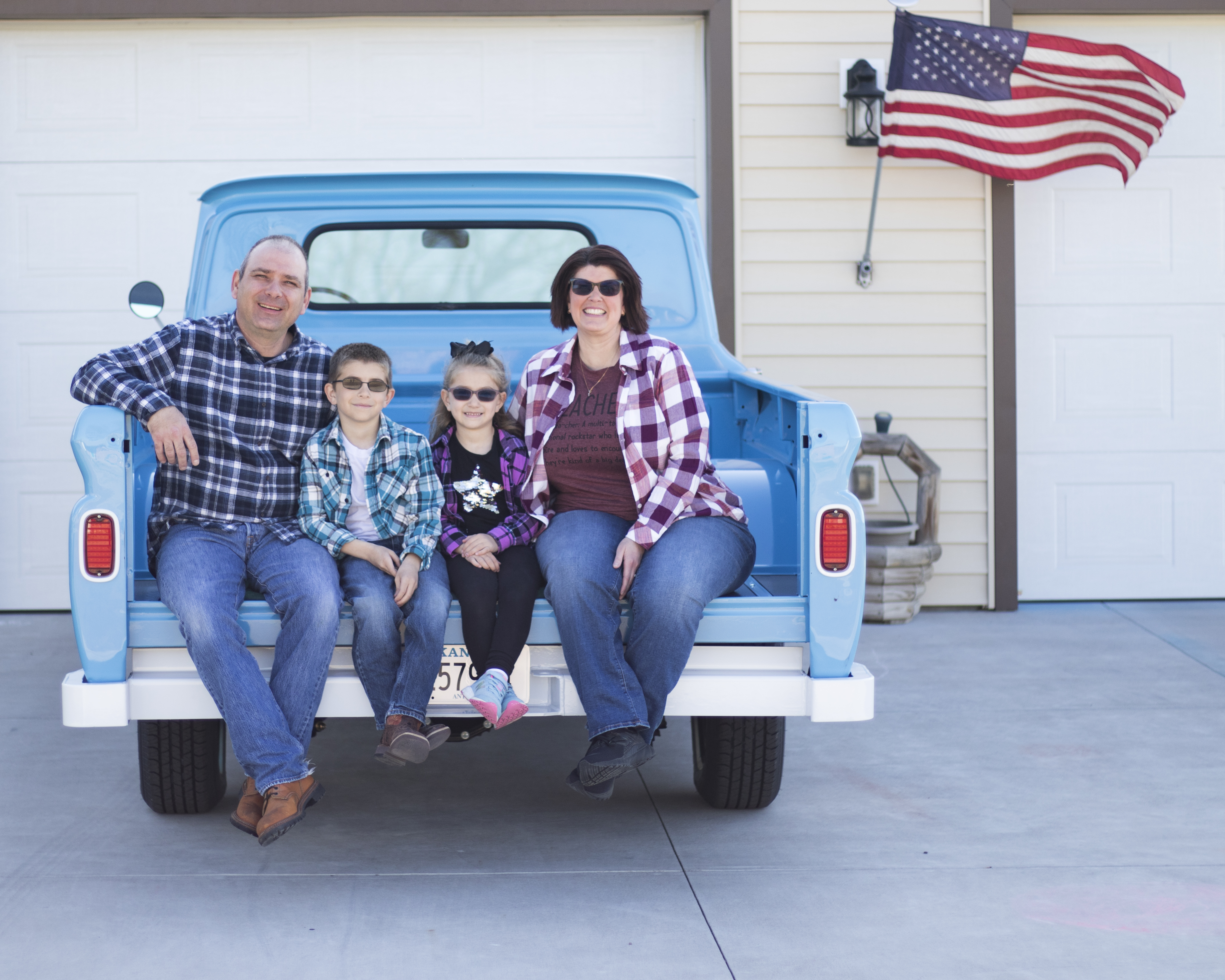 Photo of family on back of a truck