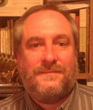 man in front of bookcase